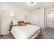 Cozy bedroom features a comfortable bed, modern lighting, and a soothing color palette, creating a relaxing atmosphere at 5640 Wandering Willow Dr, Wesley Chapel, FL 33545