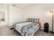A simple bedroom with carpet, a bed, and a nearby doorway at 5640 Wandering Willow Dr, Wesley Chapel, FL 33545