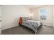 Simple bedroom features a minimalist aesthetic, window view, and black and white patterned bedding for a clean, calm space at 5640 Wandering Willow Dr, Wesley Chapel, FL 33545