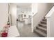 Inviting entryway showcasing stairs and an open floor plan leading to the living area at 5640 Wandering Willow Dr, Wesley Chapel, FL 33545