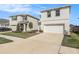 Well-maintained home showcasing a spacious driveway, attached garage, and manicured landscaping at 5640 Wandering Willow Dr, Wesley Chapel, FL 33545