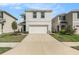Well-maintained home with a two-car garage and manicured landscaping at 5640 Wandering Willow Dr, Wesley Chapel, FL 33545