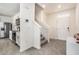 Inviting entry with stairs leading to the upper level, stainless steel kitchen appliances at 5640 Wandering Willow Dr, Wesley Chapel, FL 33545