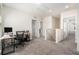 Upstairs landing featuring carpeted floor, a desk, and multiple doorways at 5640 Wandering Willow Dr, Wesley Chapel, FL 33545