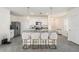 Modern kitchen island with white cabinets, pendant lighting, and seating for four, perfect for casual dining at 5640 Wandering Willow Dr, Wesley Chapel, FL 33545