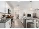 Open kitchen with granite countertops, stainless steel appliances, and a functional layout at 5640 Wandering Willow Dr, Wesley Chapel, FL 33545