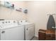 A laundry room with a washer and dryer and shelving at 5640 Wandering Willow Dr, Wesley Chapel, FL 33545
