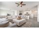 Spacious living area with a plush sectional, open to the kitchen, ideal for entertaining guests at 5640 Wandering Willow Dr, Wesley Chapel, FL 33545