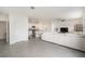 Spacious living room featuring an open floor plan with tile flooring and stainless steel appliances at 5640 Wandering Willow Dr, Wesley Chapel, FL 33545