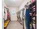 Spacious walk-in closet featuring ample storage with built-in shelving and plenty of room for organization at 5640 Wandering Willow Dr, Wesley Chapel, FL 33545