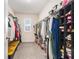 Spacious walk-in closet featuring ample storage, shelving, and natural light from the window at 5640 Wandering Willow Dr, Wesley Chapel, FL 33545