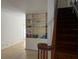 Open living room featuring built-in shelving and a staircase with wooden railing at 631 Hudson Ave, Tampa, FL 33606