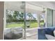 Relaxing sunroom featuring a hanging chair and serene backyard views through sliding glass doors at 6326 Waves End Pl, Apollo Beach, FL 33572