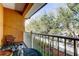 Relaxing balcony featuring a metal table, chairs, and a beautiful view of the surrounding trees at 757 Date Palm Lane, St Petersburg, FL 33707