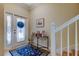 Bright foyer with a glass-paneled door and a decorated console table, accented by a patterned rug at 757 Date Palm Lane, St Petersburg, FL 33707