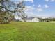 Spacious backyard with lush green grass and mature trees at 7806 Providence Rd, Riverview, FL 33578