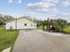 Exterior view of the home featuring a concrete driveway and well-maintained lawn at 7806 Providence Rd, Riverview, FL 33578