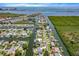 Breathtaking aerial view of a waterfront community with canals, lush greenery, and a direct access to the ocean at 8704 Thornwood Ln, Tampa, FL 33615