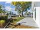 Inviting backyard space with a concrete patio, lush greenery, and waterfront access via a private dock at 8704 Thornwood Ln, Tampa, FL 33615