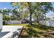 Large backyard with lush lawn, mature trees, and direct access to the canal, perfect for outdoor activities and relaxation at 8704 Thornwood Ln, Tampa, FL 33615