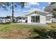 Spacious backyard featuring a concrete patio and a sliding glass door for seamless indoor-outdoor living at 8704 Thornwood Ln, Tampa, FL 33615