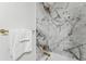 Bathroom featuring marble tile, updated faucet and towel bar at 8704 Thornwood Ln, Tampa, FL 33615