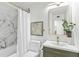 Bathroom featuring marble-style shower, updated vanity, and modern fixtures at 8704 Thornwood Ln, Tampa, FL 33615