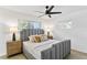 Inviting bedroom with a upholstered headboard, ample natural light, and neutral decor at 8704 Thornwood Ln, Tampa, FL 33615