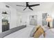 Bedroom with a view to the marble bathroom and a custom upholstered bed at 8704 Thornwood Ln, Tampa, FL 33615