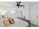 Bright bedroom featuring a large window, ceiling fan, and mirrored closet doors at 8704 Thornwood Ln, Tampa, FL 33615
