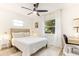 Bright bedroom with a ceiling fan, stylish decor, and a large window, offering a comfortable and inviting space at 8704 Thornwood Ln, Tampa, FL 33615