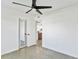 Bright bedroom with polished floors, modern ceiling fan, and a glimpse of the updated kitchen at 8704 Thornwood Ln, Tampa, FL 33615
