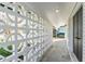 Exterior walkway featuring decorative concrete blocks and dark wood door at 8704 Thornwood Ln, Tampa, FL 33615