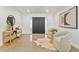 Bright foyer featuring double doors, console table, seating area, and natural light at 8704 Thornwood Ln, Tampa, FL 33615