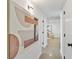 Hallway features modern art, recessed lighting, and terrazzo flooring, leading to other rooms at 8704 Thornwood Ln, Tampa, FL 33615