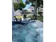 Relaxing backyard featuring a hot tub with comfortable seating, overlooking a scenic canal creating an ideal outdoor retreat at 8704 Thornwood Ln, Tampa, FL 33615