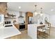 Updated kitchen featuring stainless steel appliances, a center island with seating, and modern lighting at 8704 Thornwood Ln, Tampa, FL 33615