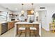 Modern kitchen featuring wood cabinets, white countertops, and stainless steel appliances at 8704 Thornwood Ln, Tampa, FL 33615