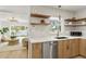 Updated kitchen featuring stainless steel appliances, modern lighting, and open shelving at 8704 Thornwood Ln, Tampa, FL 33615