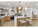 Modern kitchen features stainless steel appliances, breakfast bar with seating, and floating shelves at 8704 Thornwood Ln, Tampa, FL 33615