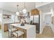 Contemporary kitchen featuring stainless appliances, island seating, and modern pendant lighting at 8704 Thornwood Ln, Tampa, FL 33615