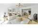 Bright living room featuring a modern chandelier, stylish furniture, and decorative accents at 8704 Thornwood Ln, Tampa, FL 33615