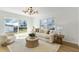 Open-concept living room with sliding doors, plush seating, and a view of the outdoors at 8704 Thornwood Ln, Tampa, FL 33615