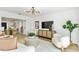Bright living room featuring a modern chandelier, stylish furniture, and decorative accents at 8704 Thornwood Ln, Tampa, FL 33615