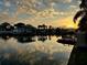 Beautiful waterfront sunset view with docks, boats, and reflections on the water at 8704 Thornwood Ln, Tampa, FL 33615