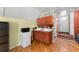 Kitchenette featuring cabinets, small refrigerator, microwave, and a sink at 915 E North Bay St, Tampa, FL 33603