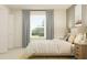 Peaceful bedroom showcasing natural light, a comfortable bed, and ample closet space at 9308 Cannon Beach Dr, Parrish, FL 34219