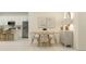 Stylish dining area with a table set for six, adjacent to an open-concept kitchen at 9324 Bonita Mar Dr, Parrish, FL 34219