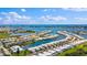 Expansive aerial view of waterfront property featuring a marina, lush landscaping, and stunning ocean views at 1 Boca Ciega Point Blvd # 213, St Petersburg, FL 33708