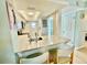 Bright kitchen featuring granite countertops, white cabinetry, a modern sink, and a convenient breakfast bar at 1 Boca Ciega Point Blvd # 213, St Petersburg, FL 33708